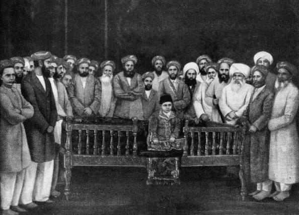 The 7-year-old Aga Khan III (1877 - 1957) at his enthronement ceremony as Imam of the Shia Ismaili Muslims in Bombay, 1st September 1885. He is surrounded by community elders and seated on the oblong wooden throne of imamate. (Photo by Keystone/Hulton Archive/Getty Images)